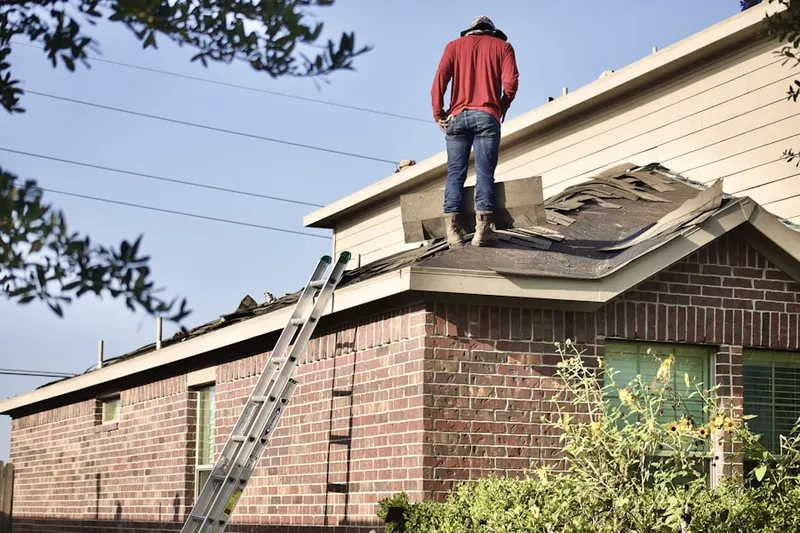Professional roofer working on a residential roof in Cassia